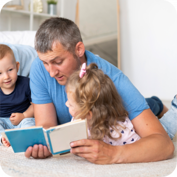 pai a ler um livro com a filha